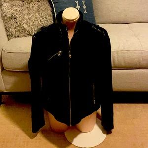 Black.  Leather sleeves front and back is wool.